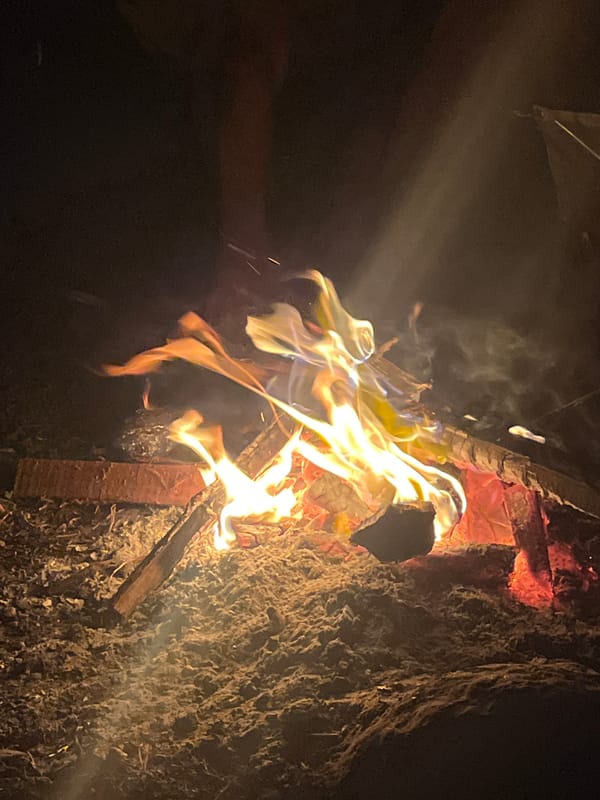 Night camping in Bali's hills — fire, fog, and a hot pot