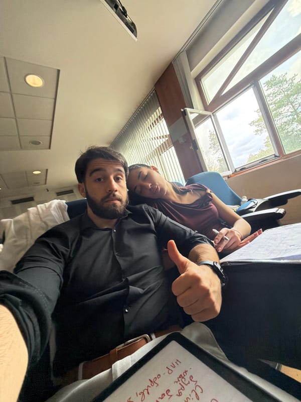 Two people photographed indoors with notepad in Sofia