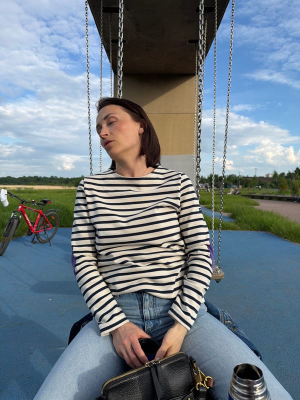 Woman rests peacefully on outdoor swing in Strelna, Russia