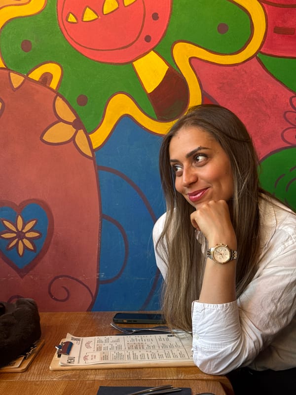 Woman dines at colorful Luxembourg cafe, mojitos served