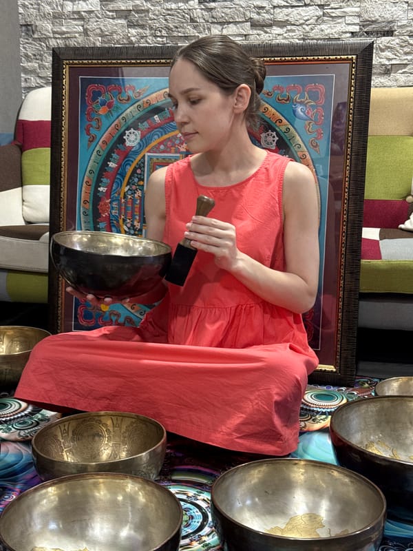 Woman plays singing bowls in Tashkent musical session