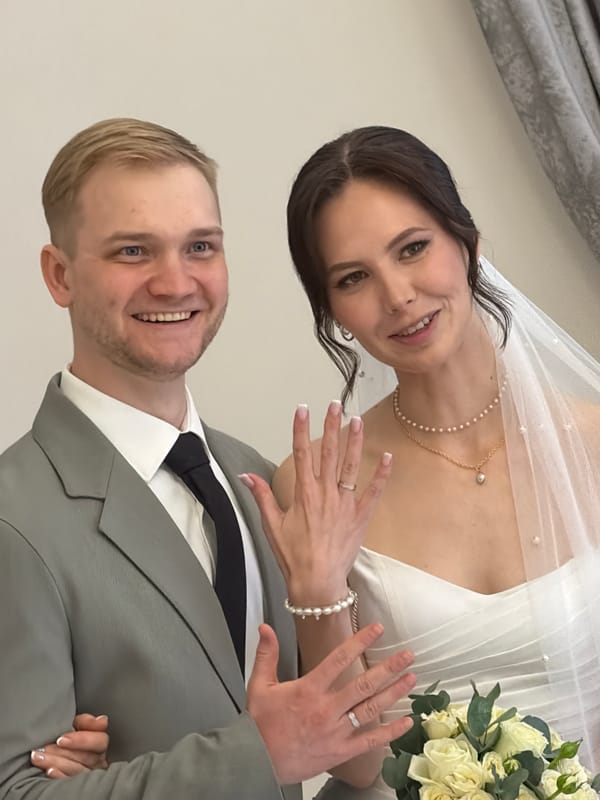Couple dressed in wedding attire poses together