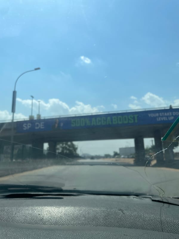 Vehicle occupant documents sky views through windshield in Abuja