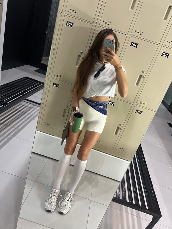 All-white gym outfit mirror selfie, locker room setting