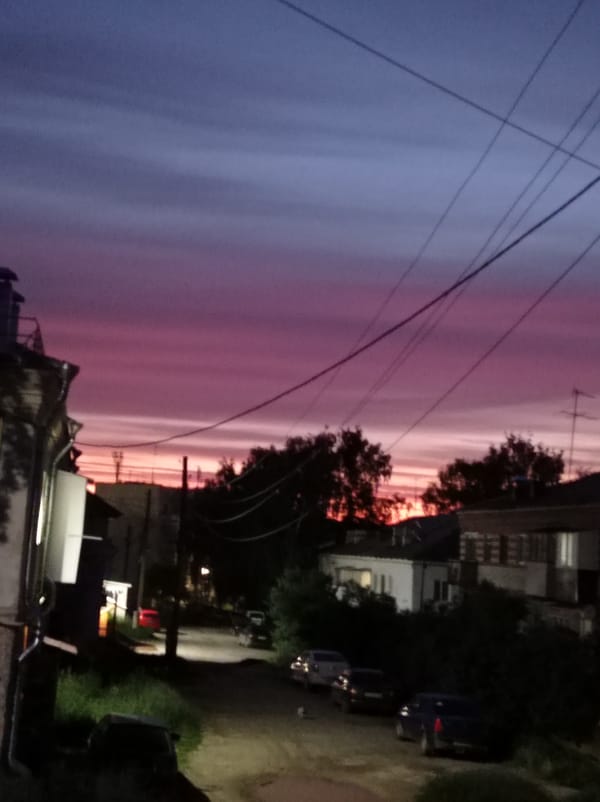 Dramatic twilight sky observed over residential Degtyarsk street