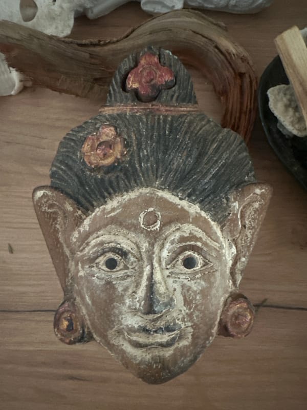 Ceremonial wooden mask and Buddha statue on display in Russia