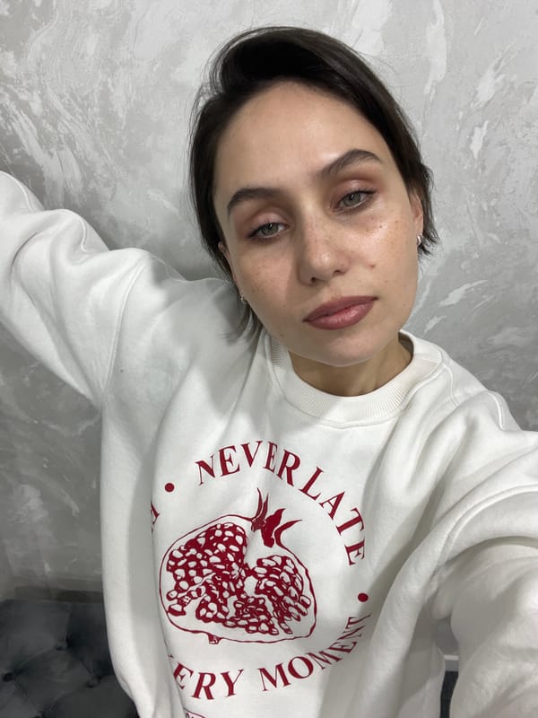Young girl makes heart gesture in Izhevsk bedroom