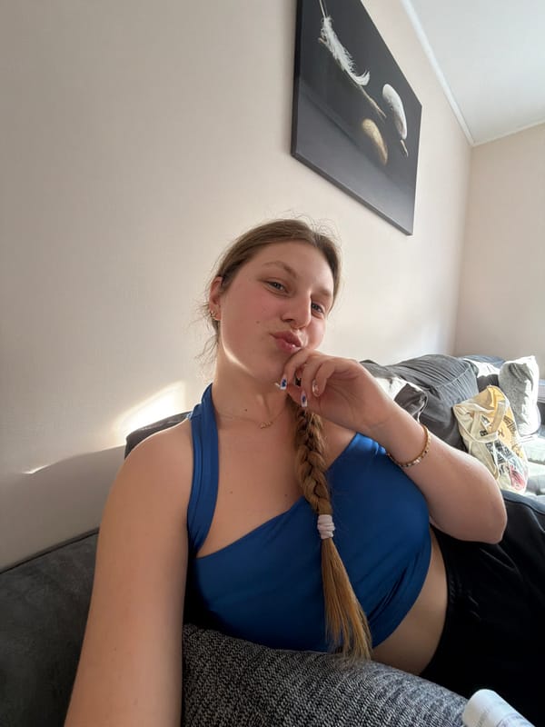 Woman relaxes with book on couch in Bulgarian home