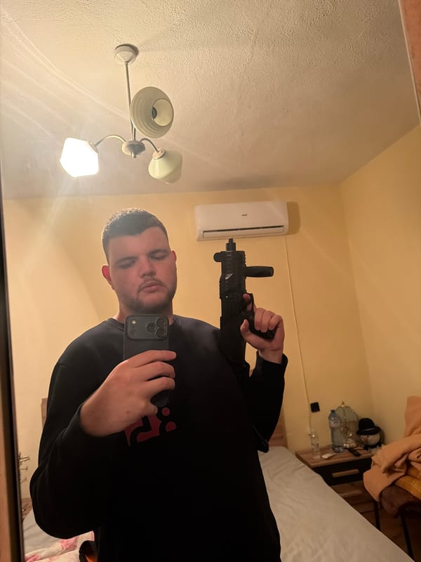 Man Takes Mirror Selfie While Holding Apparent Firearm