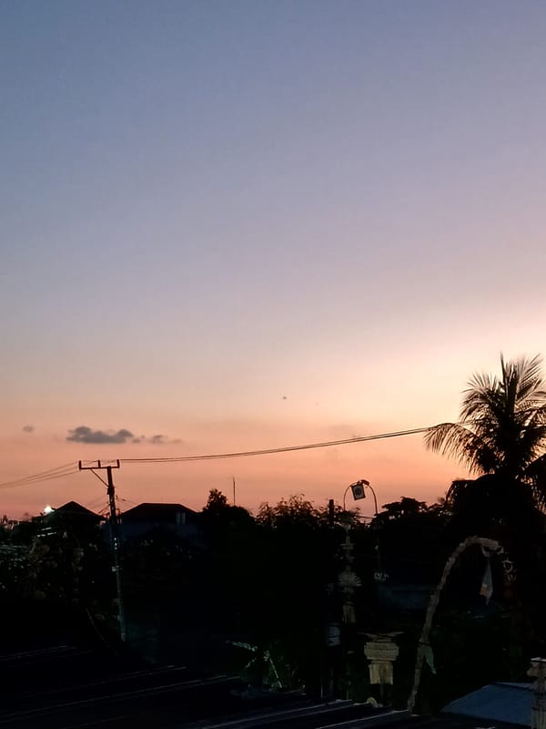 Mengwi at dawn: rice paddies, Balinese streets, and a glowing sky