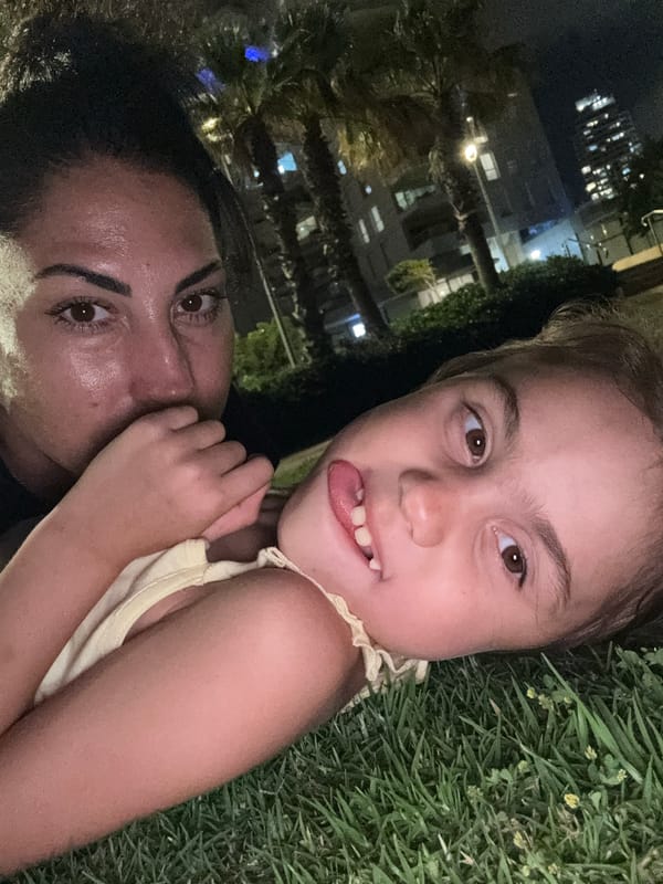 Summer night in Netanya: lawn gymnastics, flowers, and cats