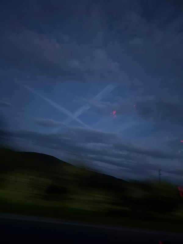 Airplane contrails spotted in twilight sky over Bulgarian village
