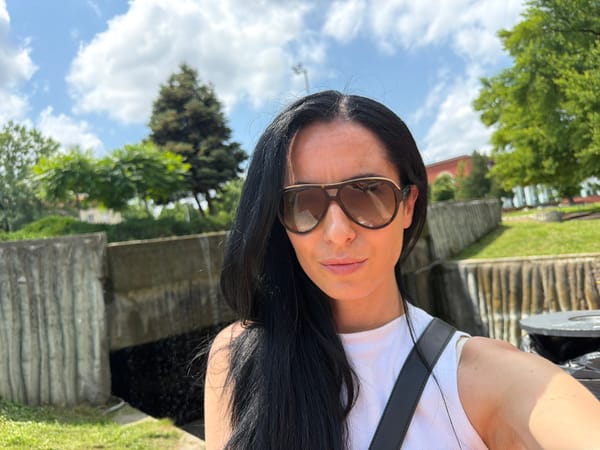 Woman takes selfies at fountain park in Pleven, Bulgaria