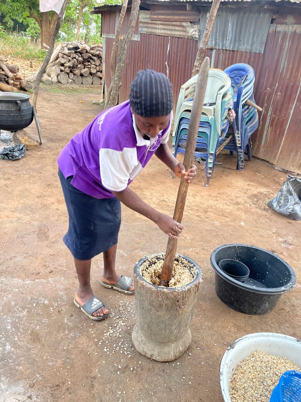 Young person processes food outdoors in Tabu, Nigeria