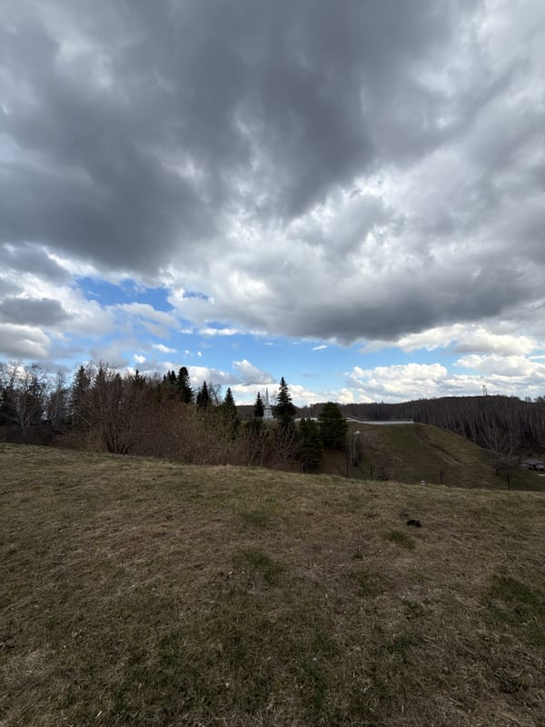 Tourist documents historic Tobolsk Kremlin under cloudy skies