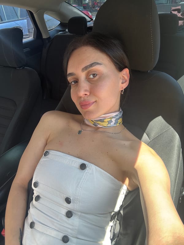 Woman takes selfies near Tbilisi monument during morning outing