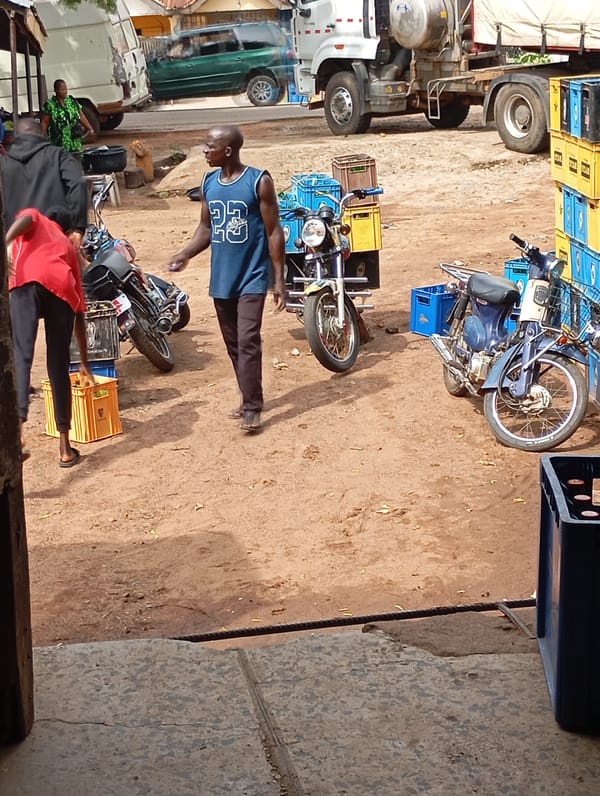 Beverage crates being loaded and moved at Shendam market