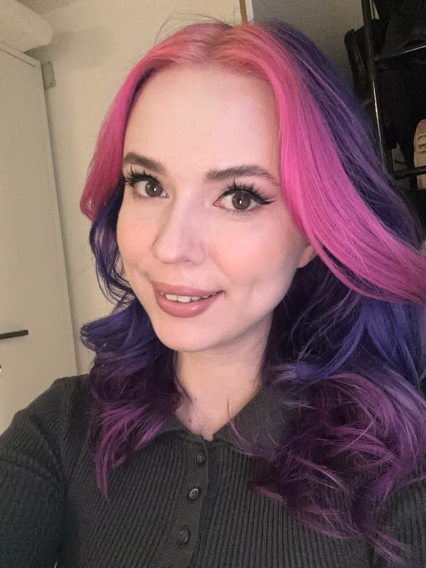 Woman takes selfies with colorful hair in Zagreb interior