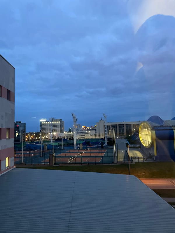 Dusk illuminates Minsk cityscape with tennis courts visible