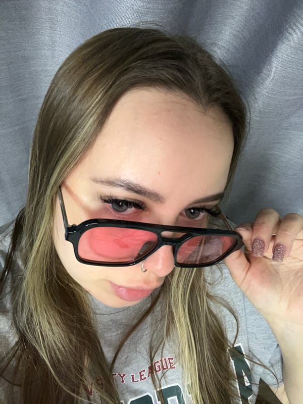 Woman rests with red-tinted glasses in Krasnodar