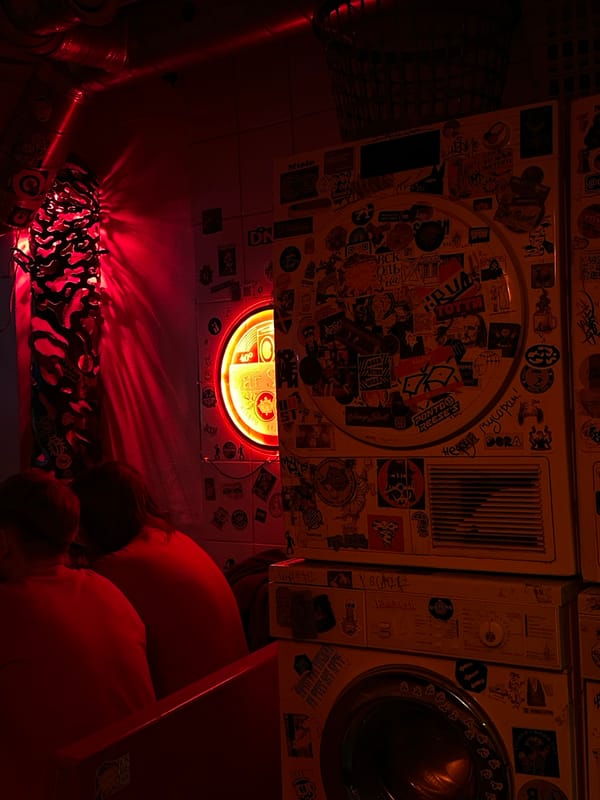 Red-lit bar scene captured in Saint Petersburg evening