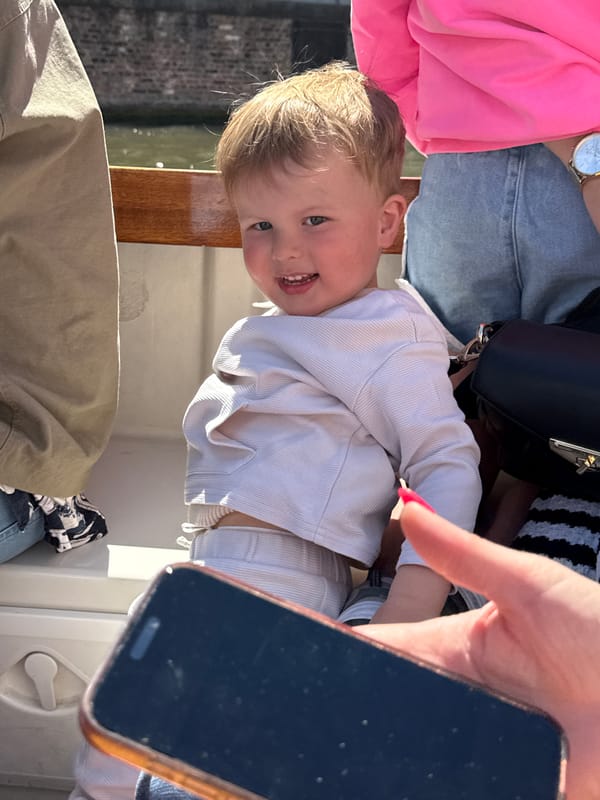 Child enjoys sunny boat ride in Bruges, Belgium