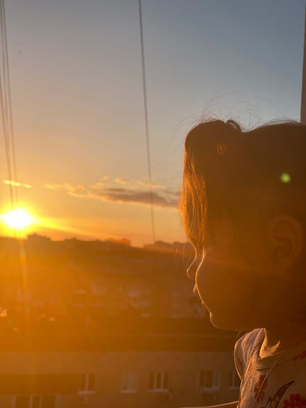 Child watches sunset from balcony in Izhevsk, Russia