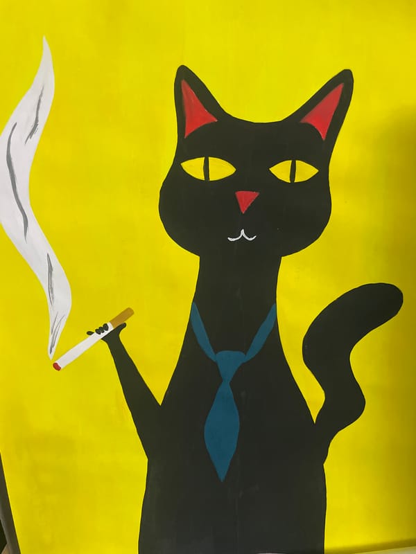 Artist's black cat observed during painting session in Chaikovsky