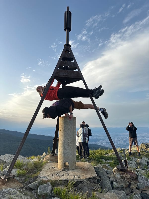 Summit hang near Bistritsa with city views and monument posing