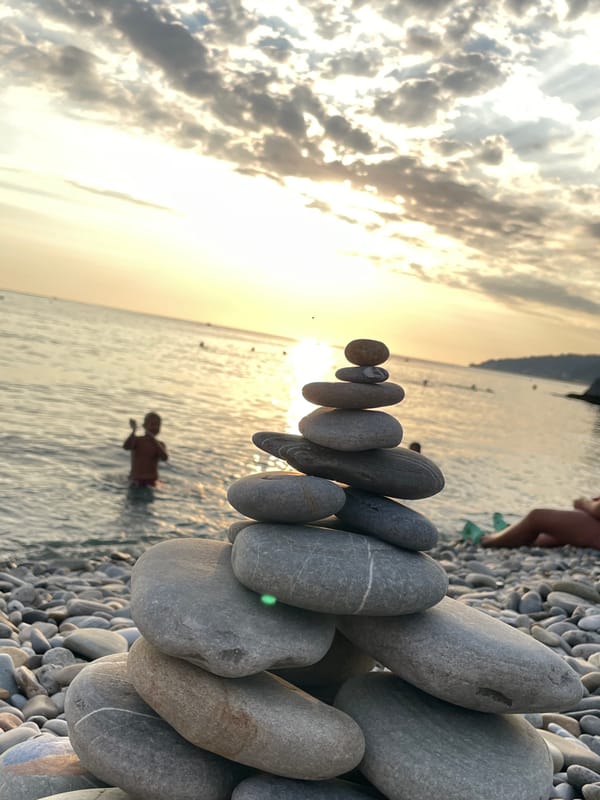 Pebble cairn on a Sochi beach at sunset