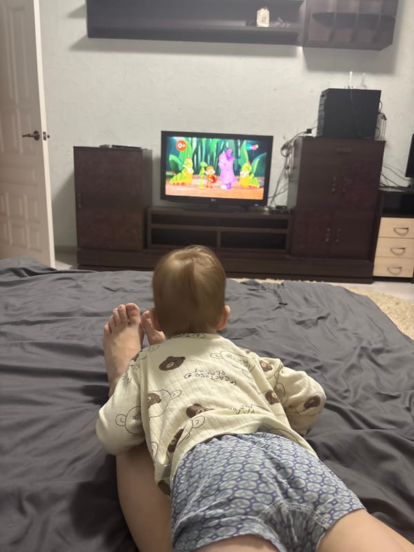 Family relaxes at home watching cartoons in Ferma, Russia