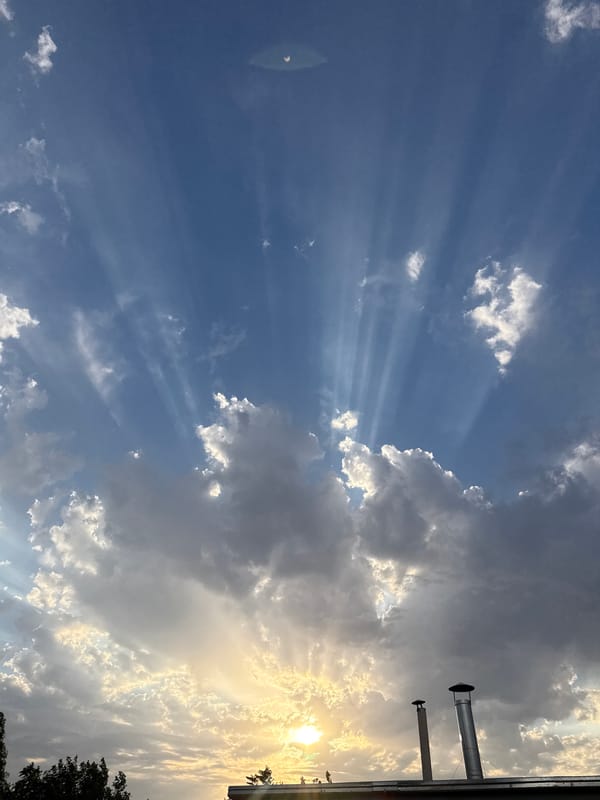 Golden sunbeams pierce through clouds over Yangibazar
