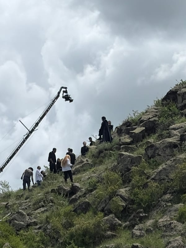 Film crew shoots on rocky hillside in Armenia