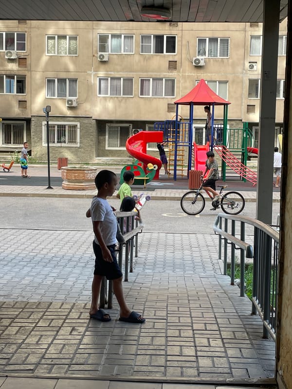 Quiet Almaty neighborhood buzzing with ordinary morning activity