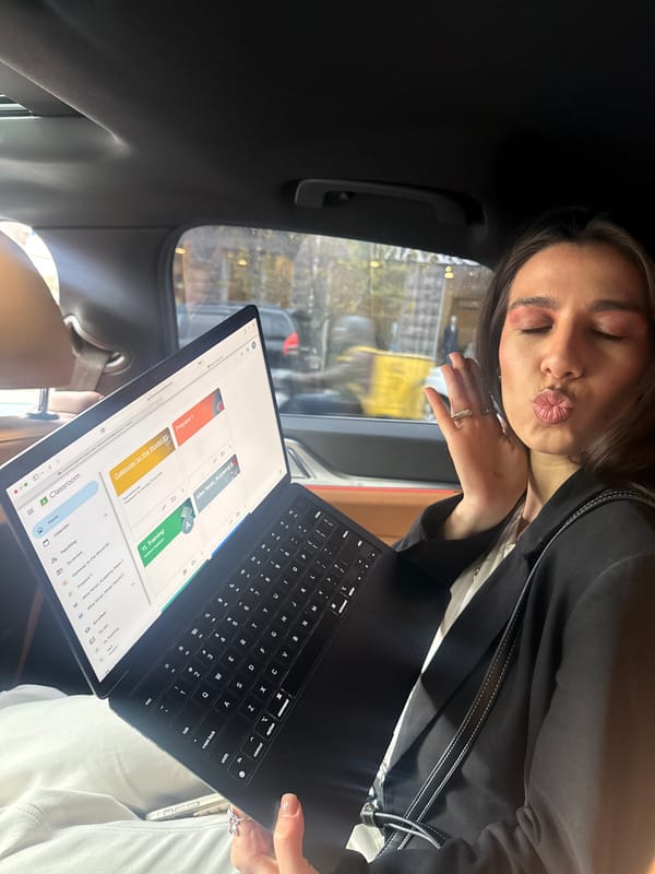 Woman poses with educational laptop in Yerevan vehicle