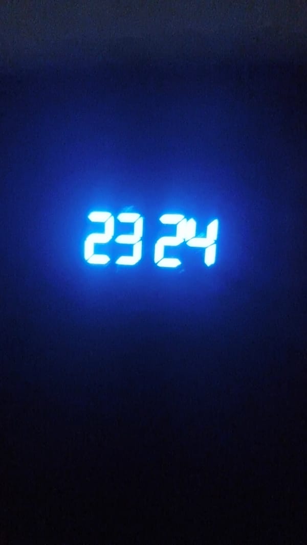 Digital clock shows 23:24 in bright blue numbers