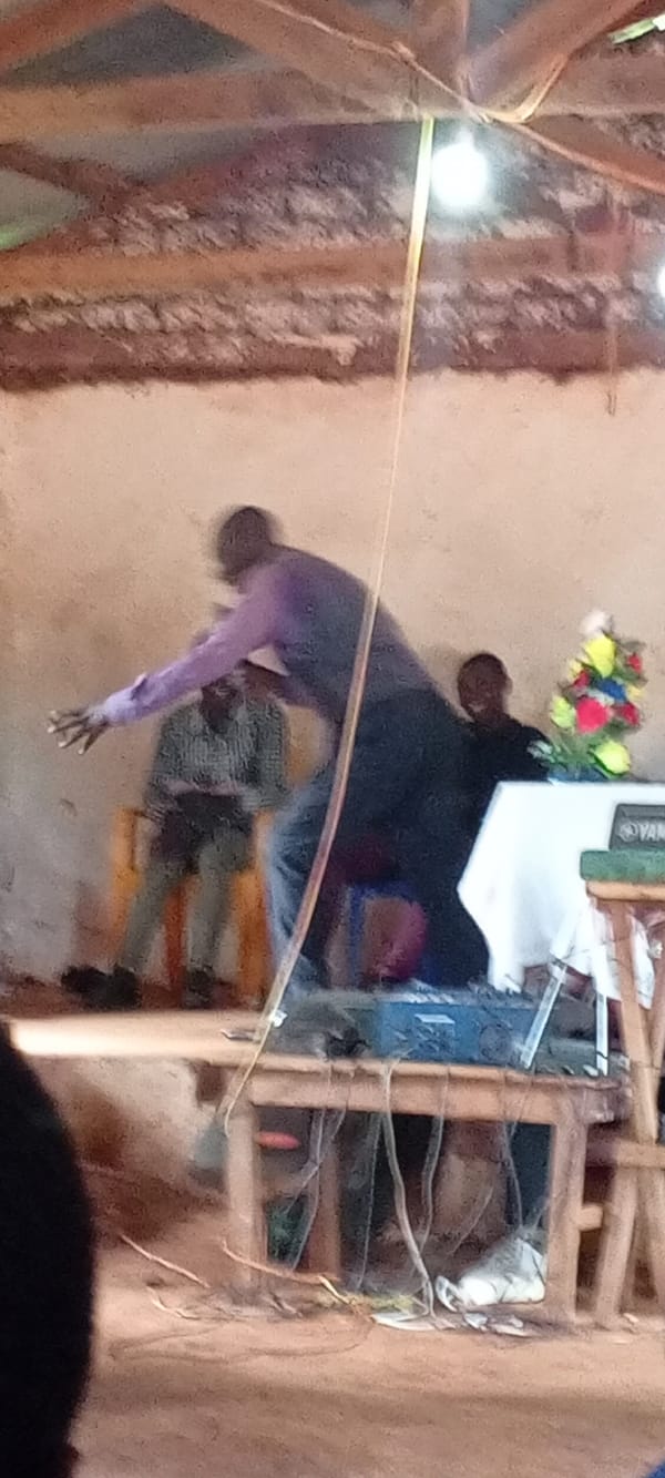 Man delivers speech to audience in Ngalula, DRC