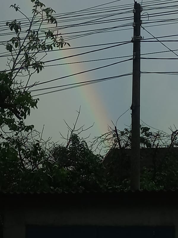 Rainbow and wet streets captured after afternoon rain in Ukraine