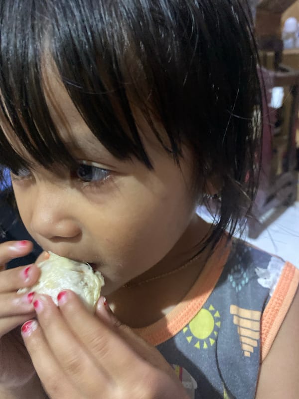 Kids and durian at a small market stall in Ta', Indonesia