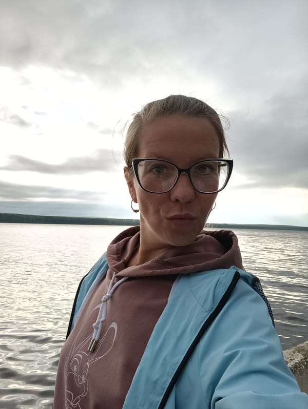 Woman takes early morning selfies by water in Chaikovsky