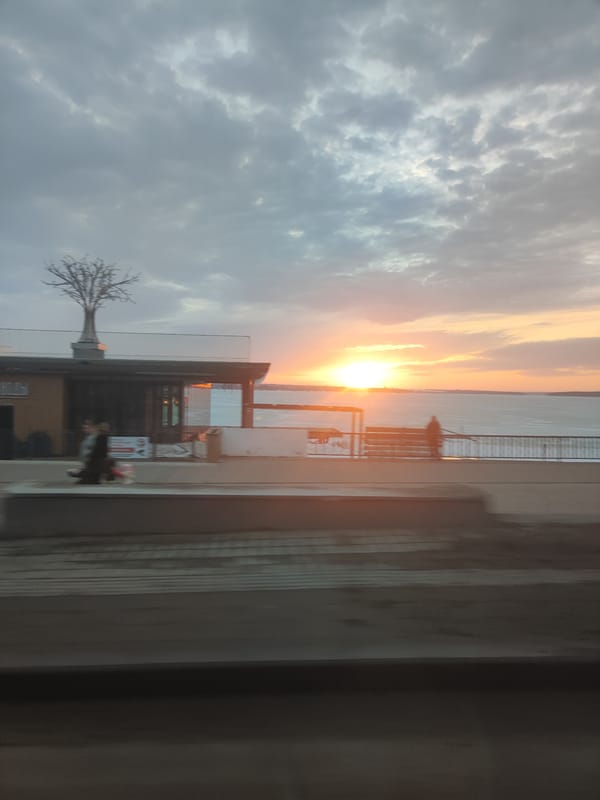Sunset over water captured from moving vehicle in Votkinsk