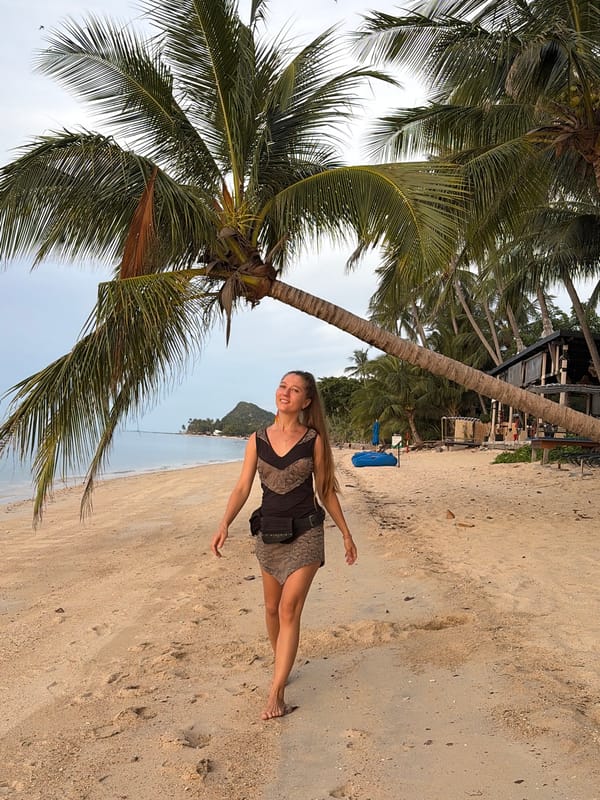 Sunset beach gathering with rainbow flags in Baan Tai, Thailand