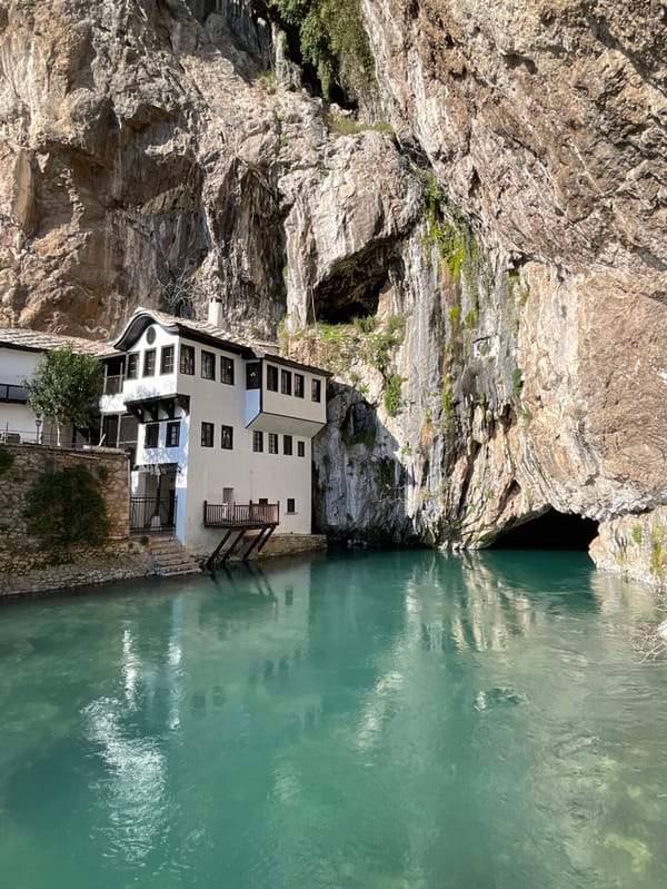 Tourist documents historic Blagaj Tekke monastery at Buna River source