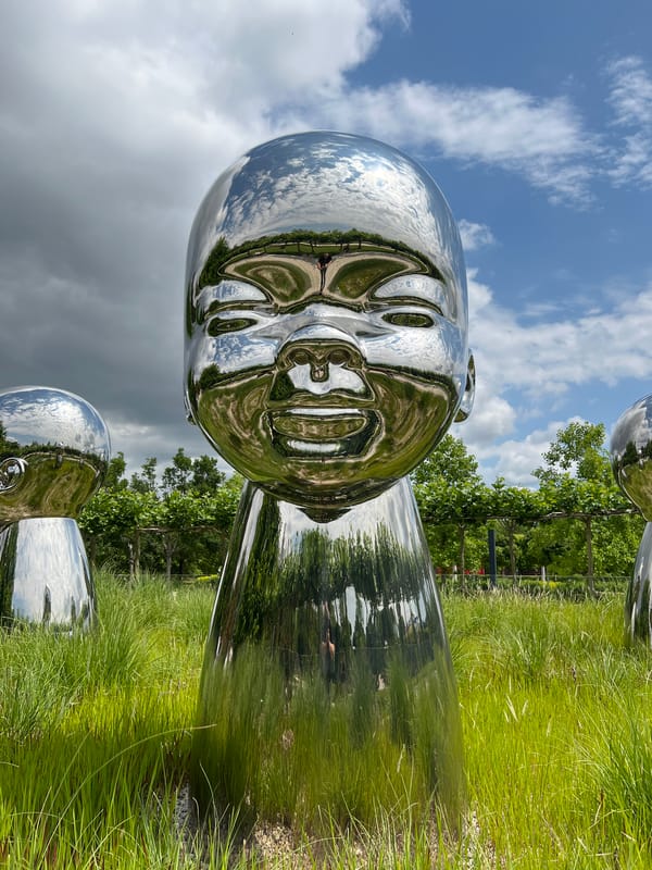 Morning scenes around reflective baby head sculptures in Krasnodar