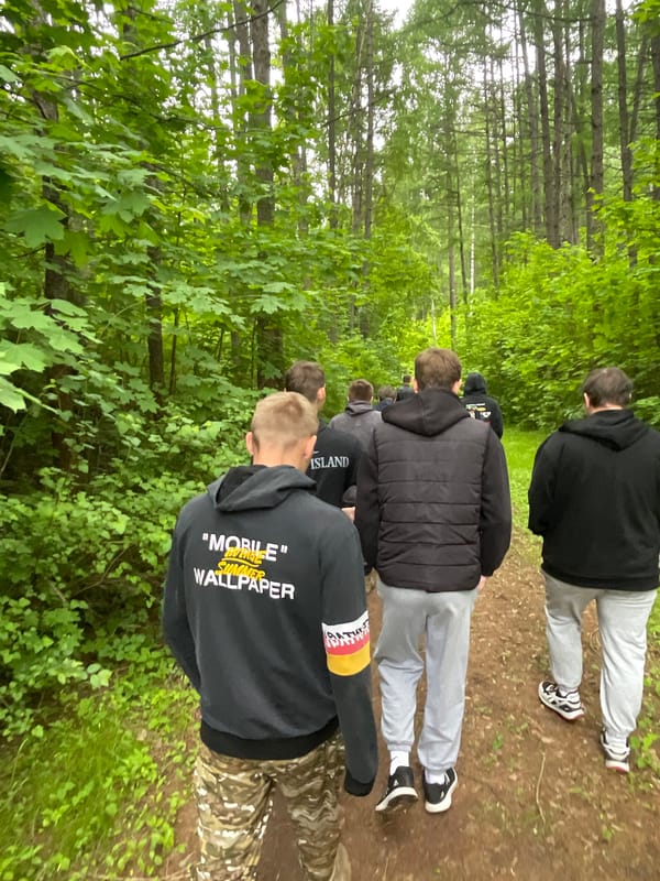 Young men walk forest paths in Krasnye Baki Russia
