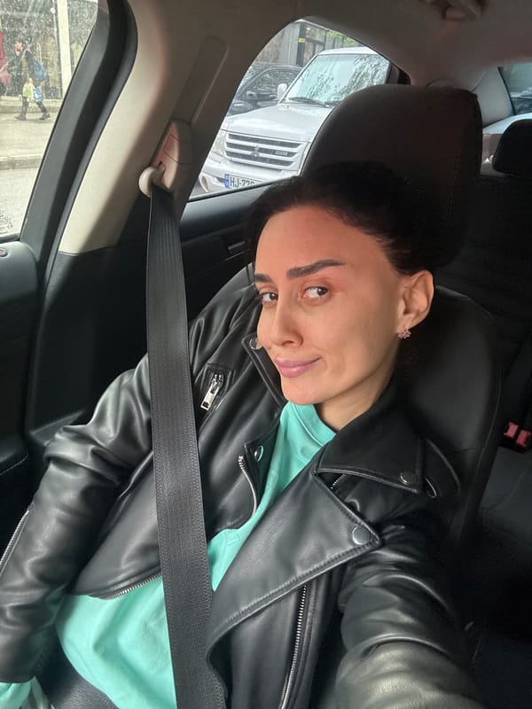 Two people photographed inside parked car in Tbilisi