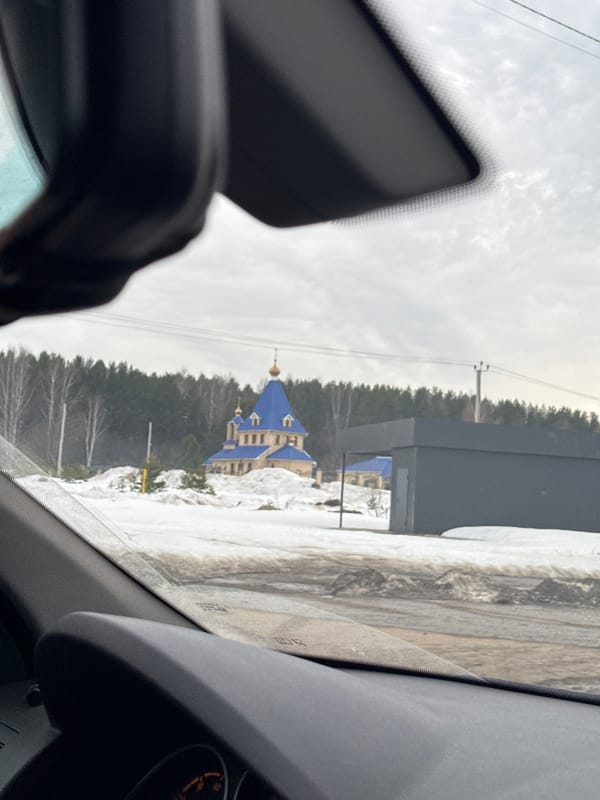Vehicle view of snow-covered landscape in Chaikovsky, Russia