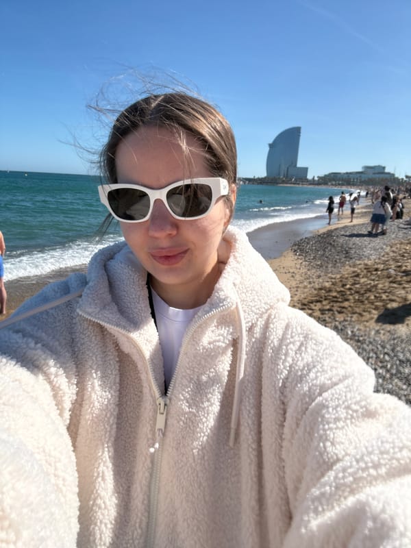 Woman takes selfie at Barcelona's Barceloneta Beach