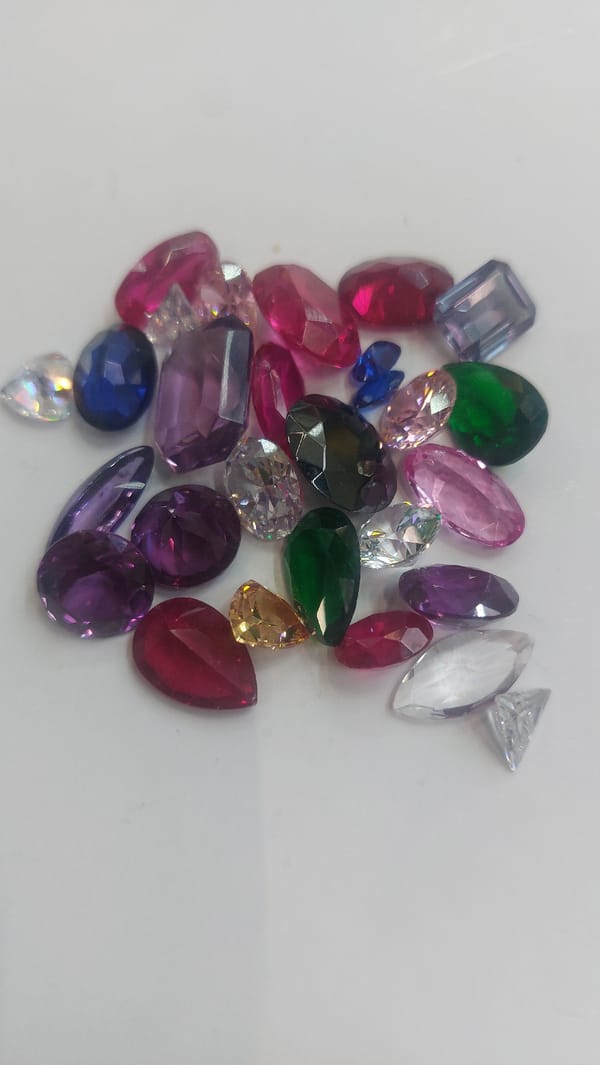 Colorful gemstones scattered on white surface in Novosibirsk