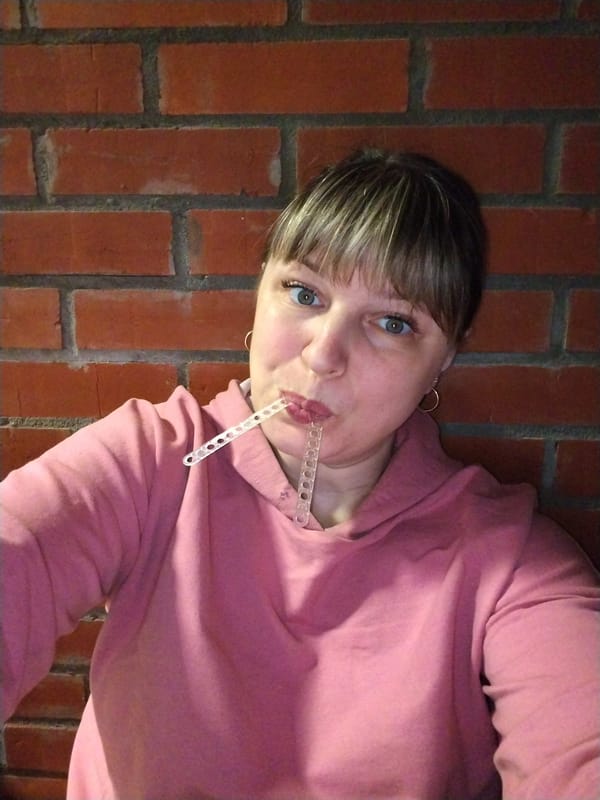 Woman takes playful selfies while eating in Rusanovo